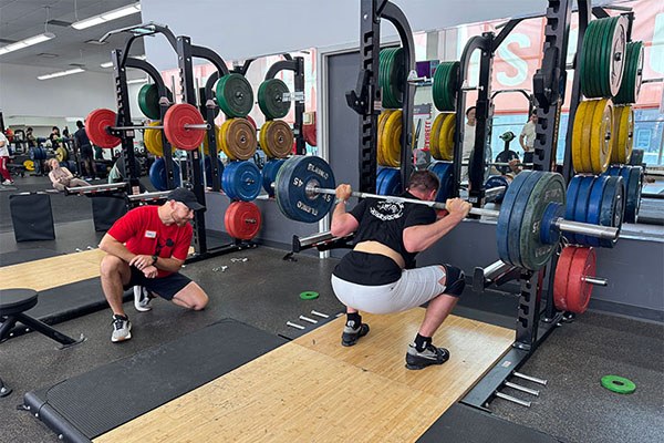 aaron at the bottom of a 295 squat