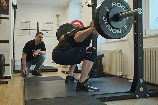 francesco coaches gherard on the squat