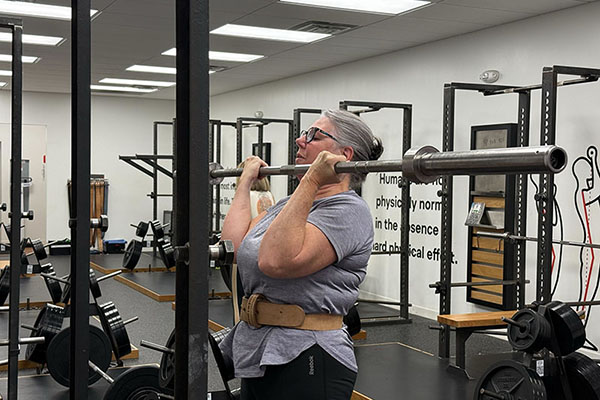 carol in the middle of a barbell curl