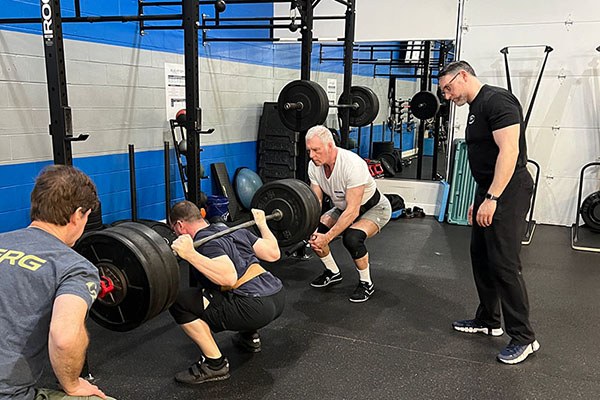 alex at the bottom of a 255 pound squat