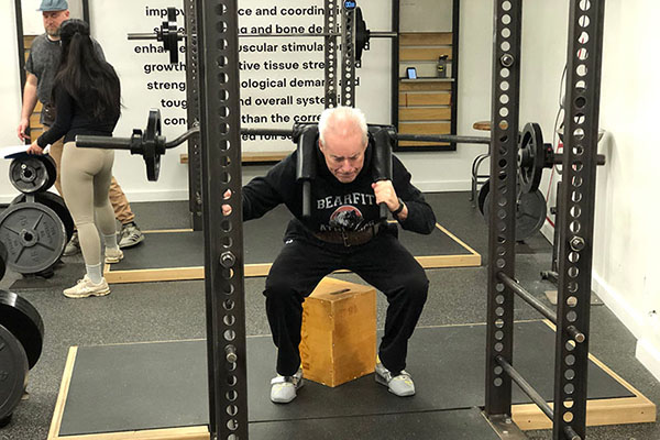 mark training with a safety bar squat