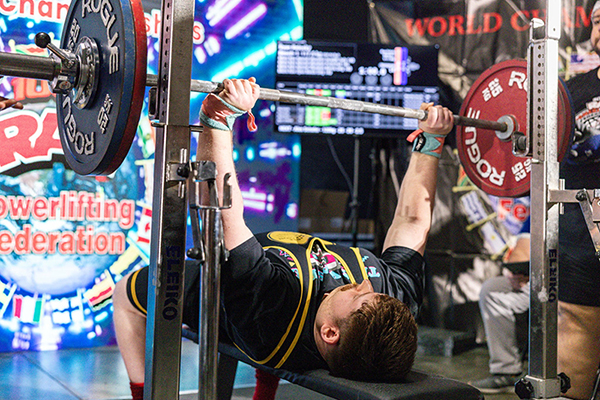 ryan relosky bench pressing at a meet