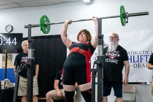 renee mathis pressing in a strengthlifting meet