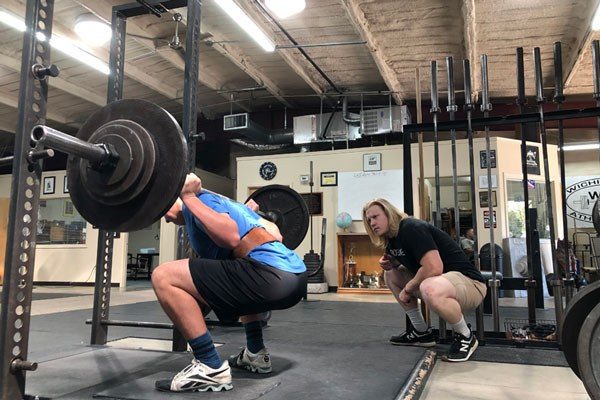 chase coaches a new lifter in the squat