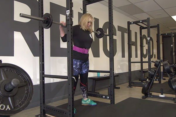 anne under the bar getting ready to squat