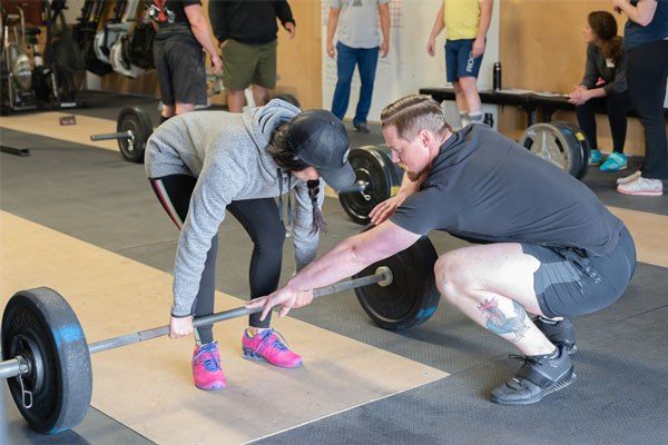 coaching the start of a pull at a starting strength seminar