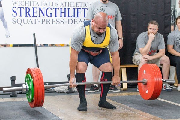 carl raghavan starts his deadlift on the competition platform