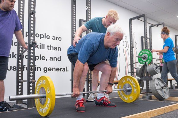 coaching an older man in the deadlift