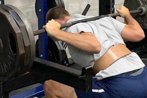 close up of a low bar barbell squat