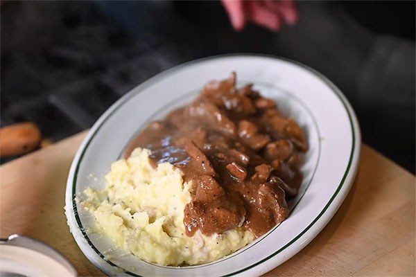 plate of sirloin tips served over mashed potatoes