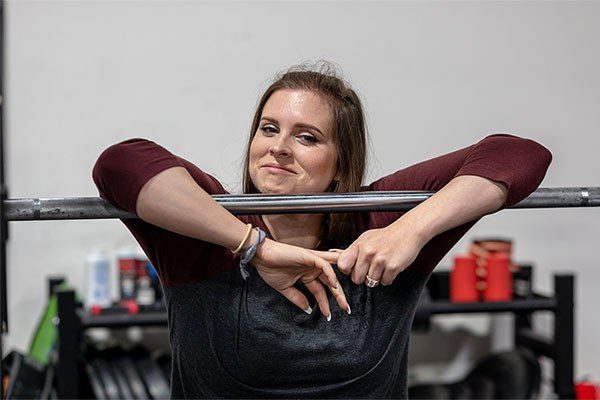 marie kunkel next to a bar in a gym