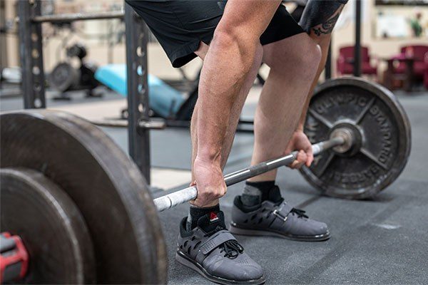 close up of bar over midfoot in a deadlift