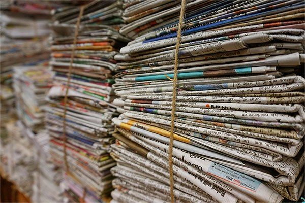 stacks of propaganda papers newspapers
