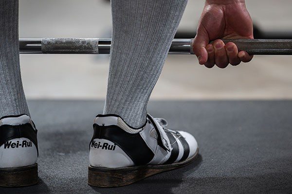 close up of lifter wearing weightlifting shoes