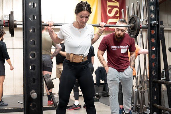 lifter at the top of a squat