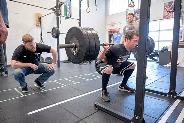 andrew lewis coaching a squat