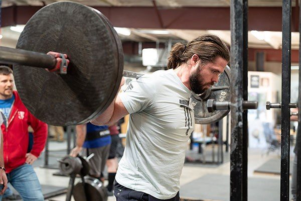 lifter at the top of a squat