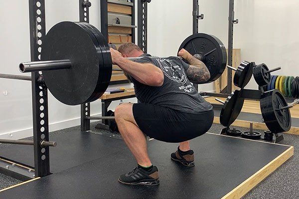 lifter at the bottom of a squat