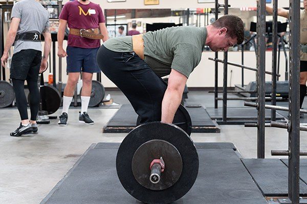 a lifter sets his back as he prepares to deadlift