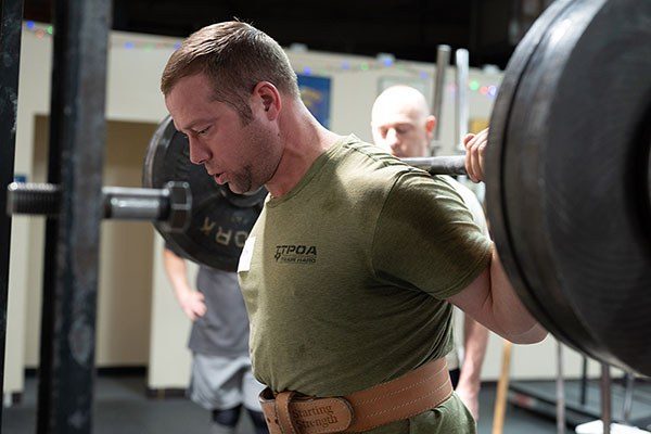 lifter at the top of a squat