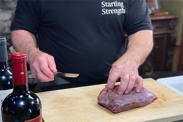 rippetoe preparing a piece of venison for cooking