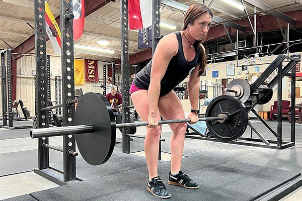 lifter at the top of a halting deadlift