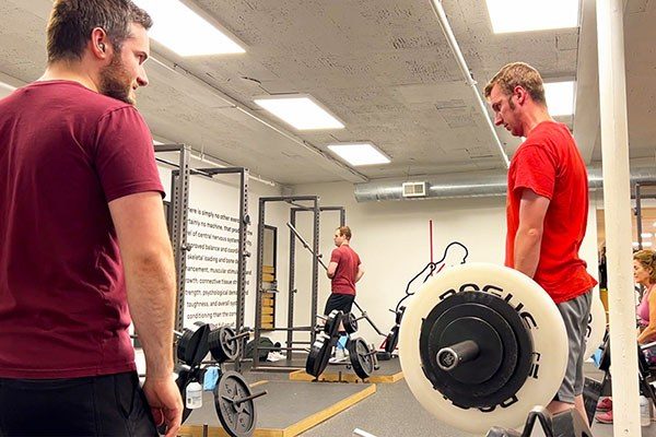 michael shammas working as a strength coach at starting strength boston