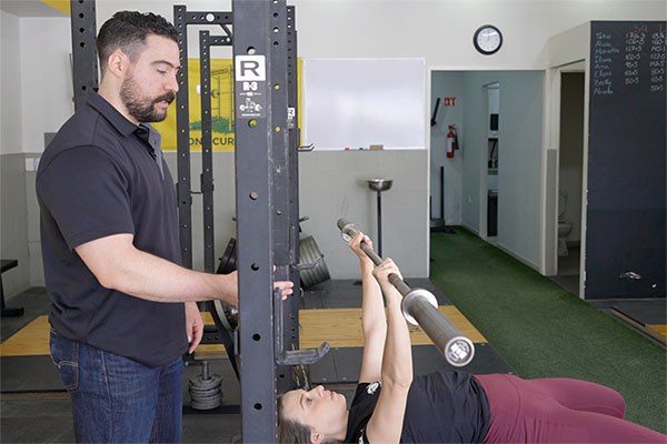 hari fafutis coaches the bench press