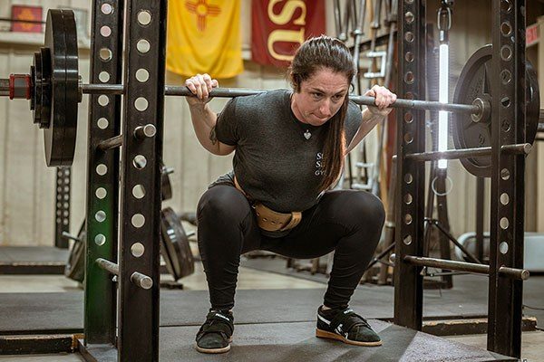 bre hillen at the bottom of a squat