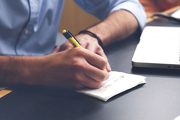 close up of hands of writer writing