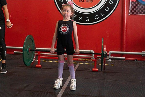 starting strength kid tori locking out a deadlift