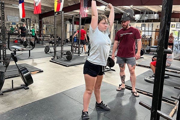 young lifter training her press