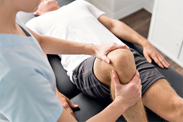 a man examines a knee