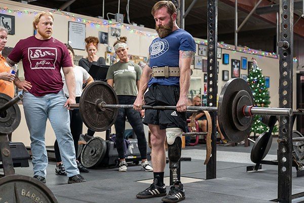 bruce trout locks out a deadlift at a starting strength seminar