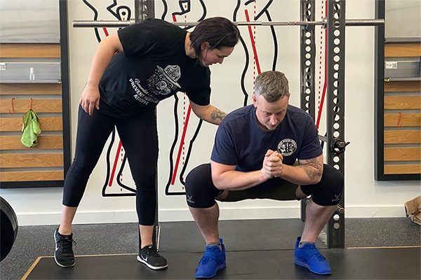 starting strength coach cueing a trainee