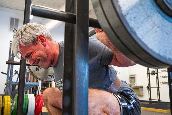 mike ditson at the bottom of a squat