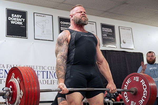 josh wells locking out a deadlift in a strengthlifting competition