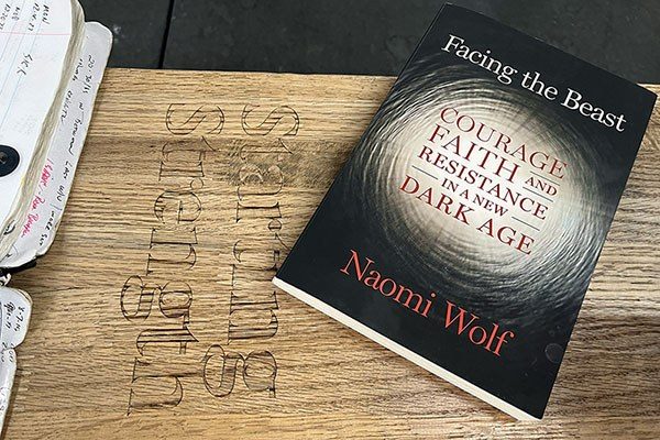naomi wolf's book facing the beast on a starting strength bench
