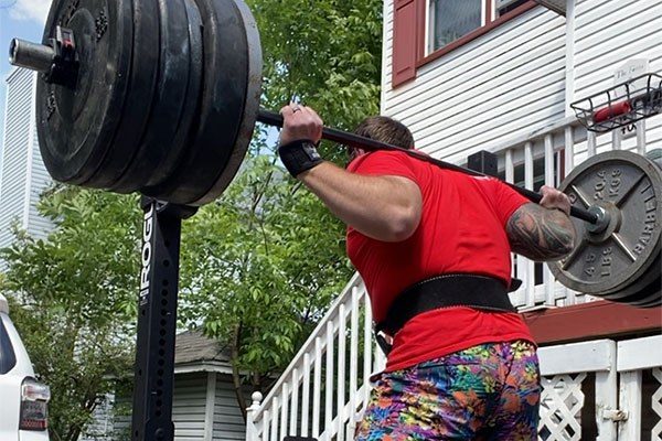 marty fox prepares to squat in his driveway gym
