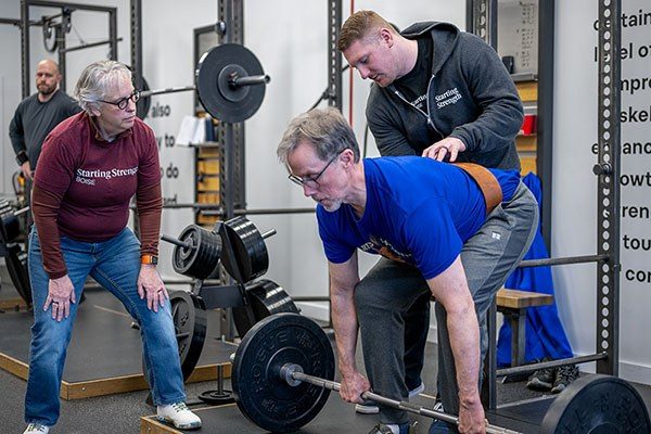 coaching a lifter through a deadlift at boise