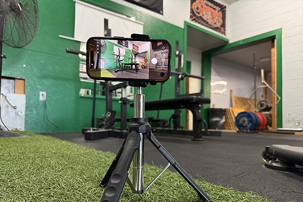 camera set up on tripod to record bench press